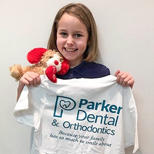 young woman holding Parker dental shirt
