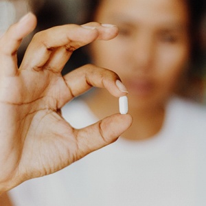 person holding a small pill