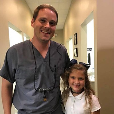 Dr. smiling with a young patient.