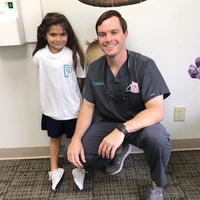 Dr. posing with a young patient.