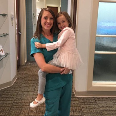 Rebecca posing with a young patient.