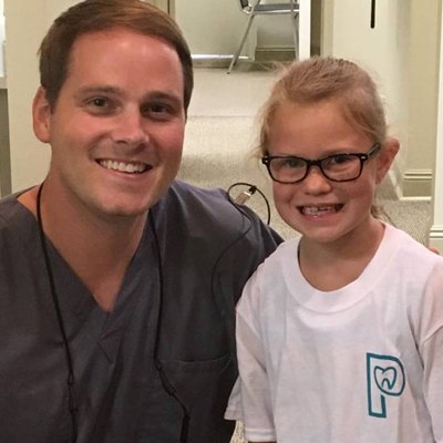Dr. posing with a young patient.