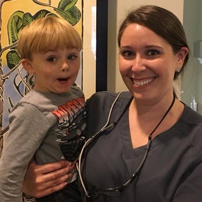 Maggie posing with a young patient.