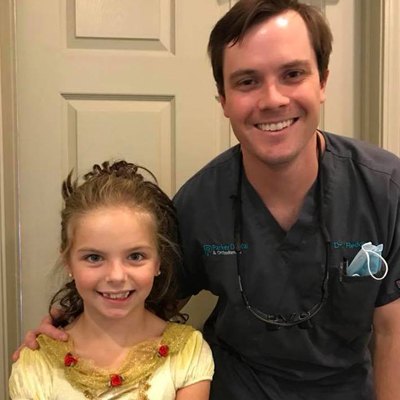 Dr. smiling with a young patient.