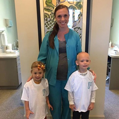 Misty posing with two young patients.