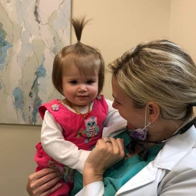 A hygienist posing with a young patient.