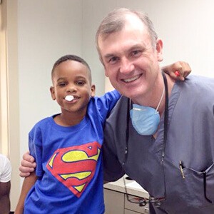 Dr. Parker smiling with young boy