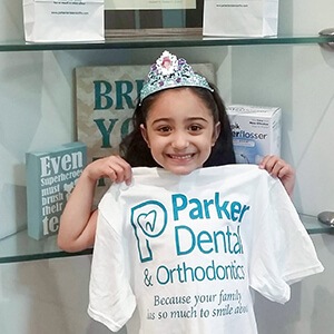 young girl with tiara smiling