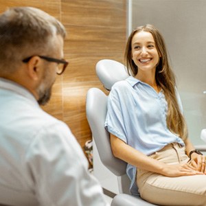 Female patient smiling at dentist at dental appointment