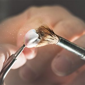 A dental crown being brushed