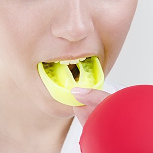 Teen girl placing mouthguard