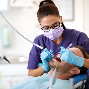 dental hygienist cleaning a patient’s teeth