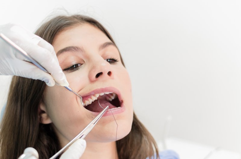 teenage girl having braces placed by orthodontist in Mobile