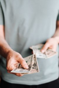 Man paying for the cost of root canals