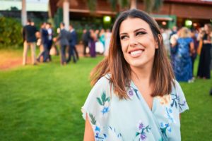 Woman smiling while attending a wedding.