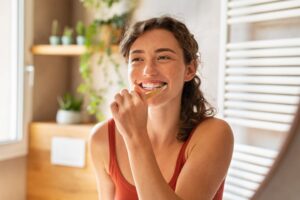 Young woman brushing teeth.
